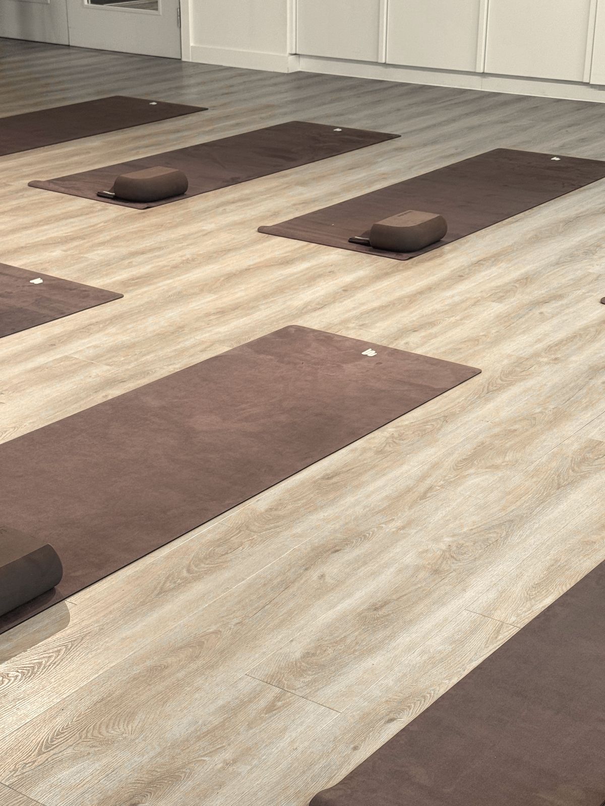 Brown mats and blocks laid out across the floor before anyone arrived
